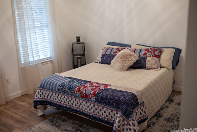 bedroom with hardwood / wood-style floors