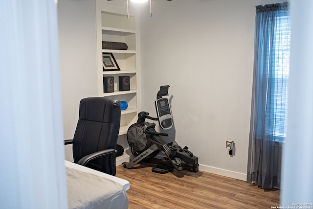 home office featuring hardwood / wood-style floors and ceiling fan