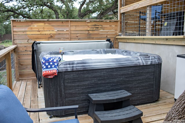 wooden deck with a hot tub