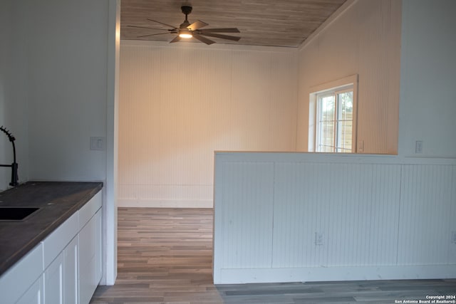 kitchen with white cabinets, hardwood / wood-style flooring, ceiling fan, and wooden ceiling