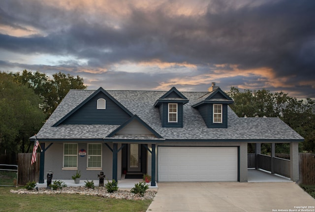 view of front facade featuring covered porch and a garage