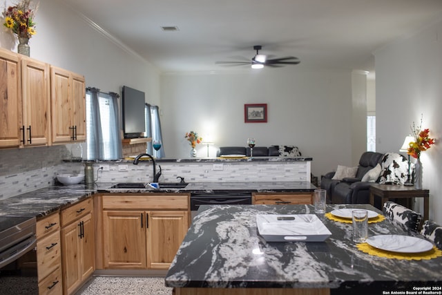 kitchen with ceiling fan, sink, dark stone counters, and tasteful backsplash