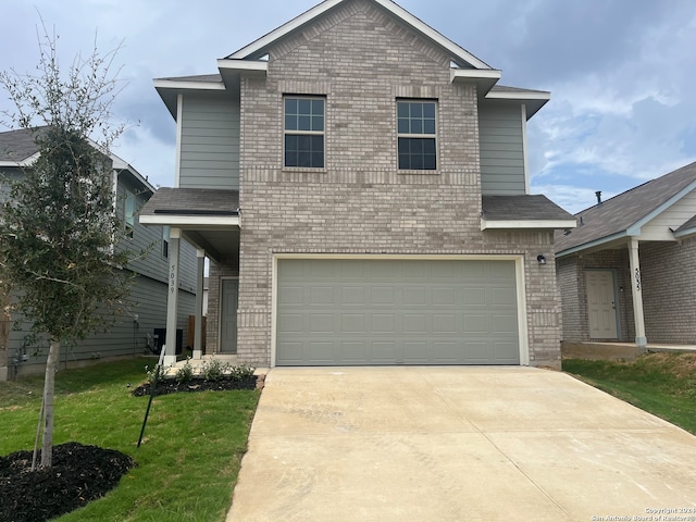 front facade with a garage and a front yard