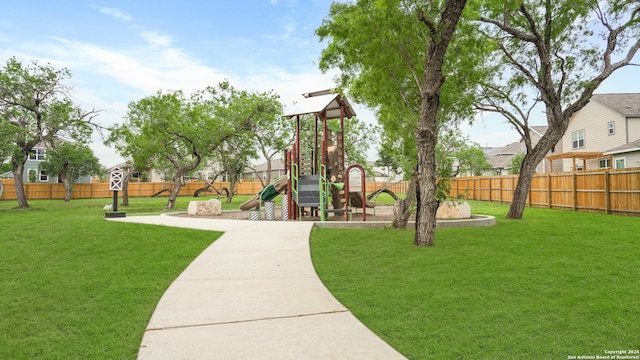 view of playground with a lawn