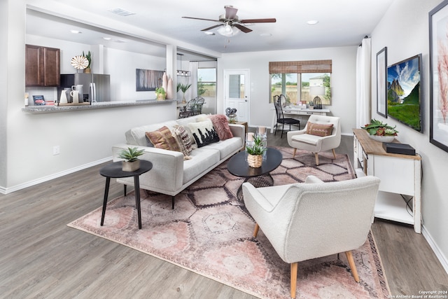 living room featuring ceiling fan and dark hardwood / wood-style flooring