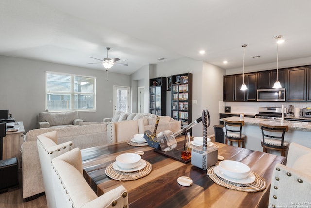 dining area with lofted ceiling, ceiling fan, and hardwood / wood-style flooring