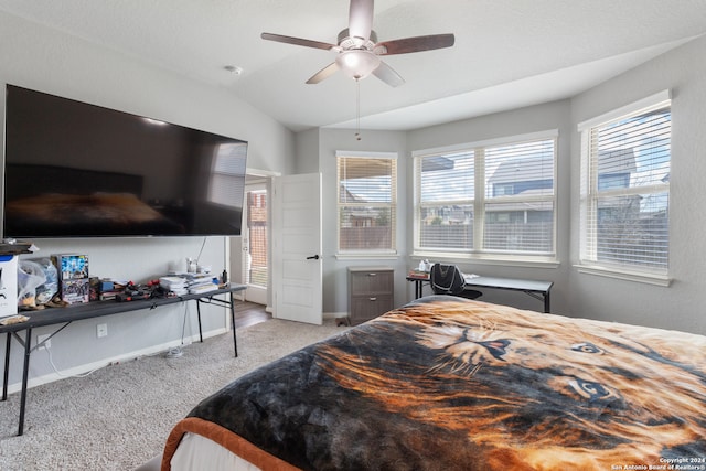 bedroom with light colored carpet, multiple windows, vaulted ceiling, and ceiling fan