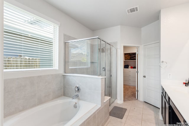 bathroom featuring vanity, tile patterned floors, and shower with separate bathtub