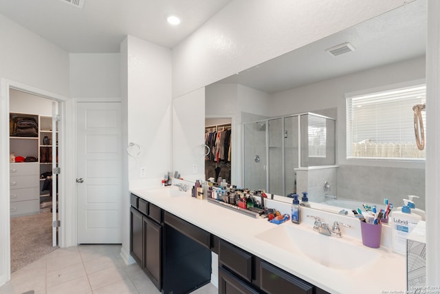 bathroom with tile patterned flooring, vanity, and independent shower and bath