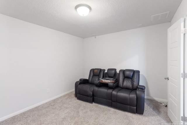 home theater with light carpet and a textured ceiling