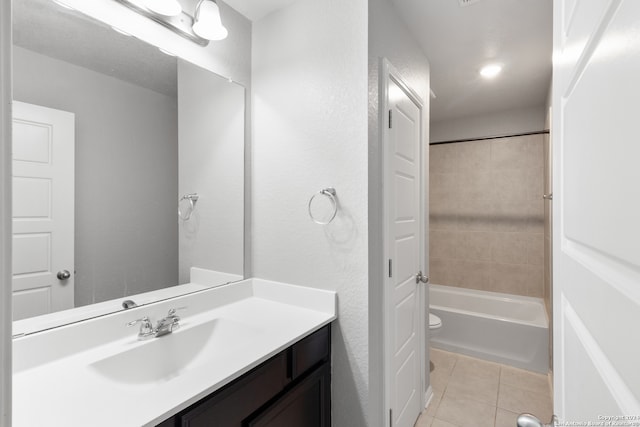 full bathroom with tile patterned flooring, vanity, toilet, and tiled shower / bath combo