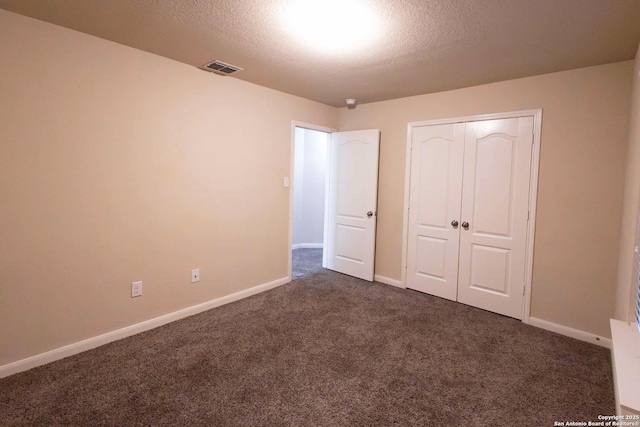 8446 Buckhorn Parke, San Antonio, TX 78254 - unfurnished bedroom with baseboards, a textured ceiling, visible vents, and dark colored carpet