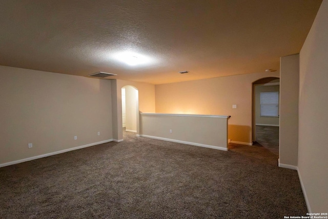 8446 Buckhorn Parke, San Antonio, TX 78254 - unfurnished room with carpet, baseboards, a textured ceiling, arched walkways, and visible vents