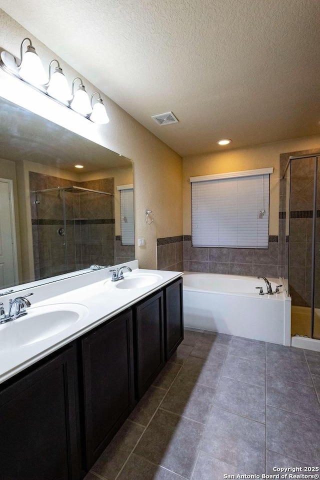 8446 Buckhorn Parke, San Antonio, TX 78254 - bathroom with a shower stall, visible vents, a sink, and a textured ceiling