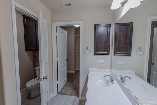 8446 Buckhorn Parke, San Antonio, TX 78254 - full bathroom featuring visible vents, baseboards, toilet, vanity, and tile patterned flooring