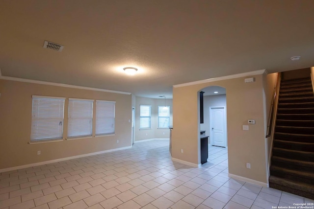 8446 Buckhorn Parke, San Antonio, TX 78254 - spare room with crown molding, stairs, light tile patterned floors, arched walkways, and visible vents