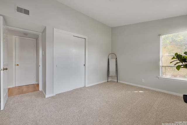 unfurnished bedroom with a closet and carpet floors