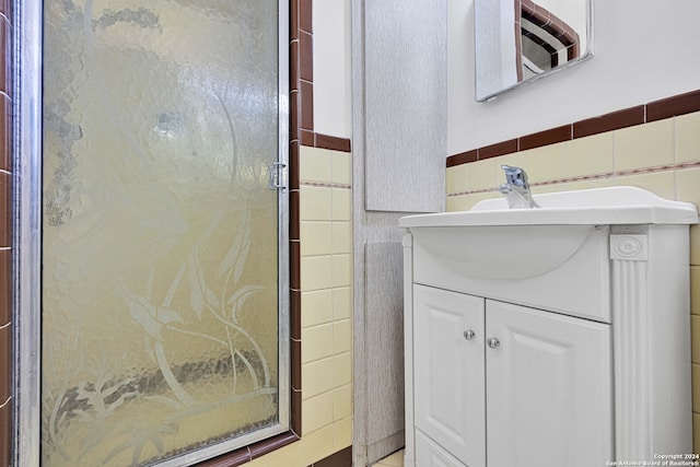 bathroom featuring tile walls and vanity