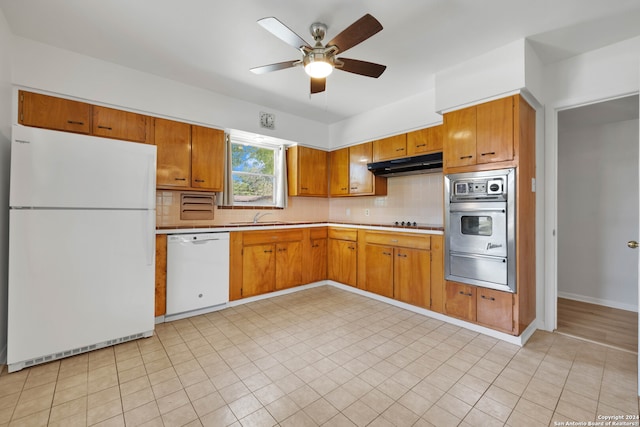 kitchen featuring ceiling fan, sink, white appliances, and tasteful backsplash