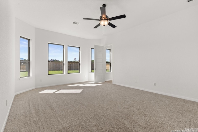 carpeted spare room with ceiling fan