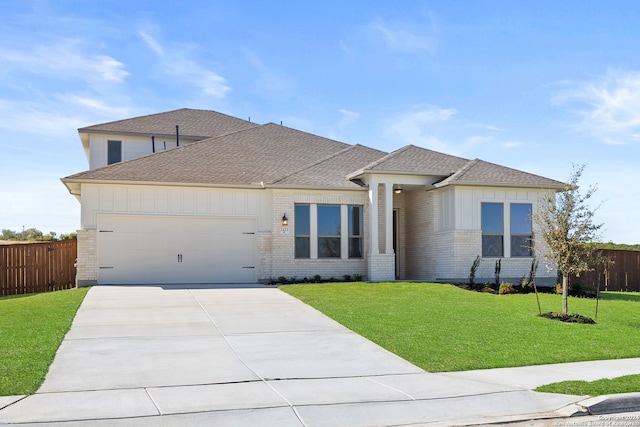 view of front facade with a front yard and a garage