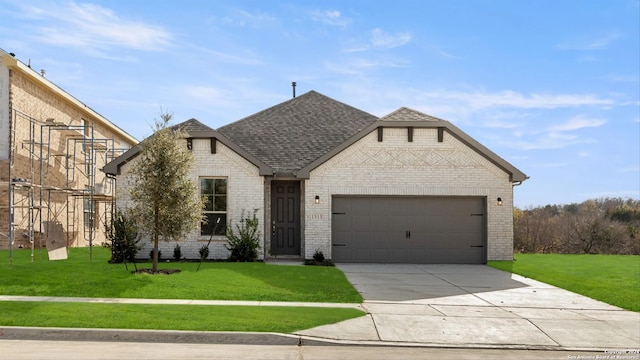 view of front of house featuring a garage and a front lawn