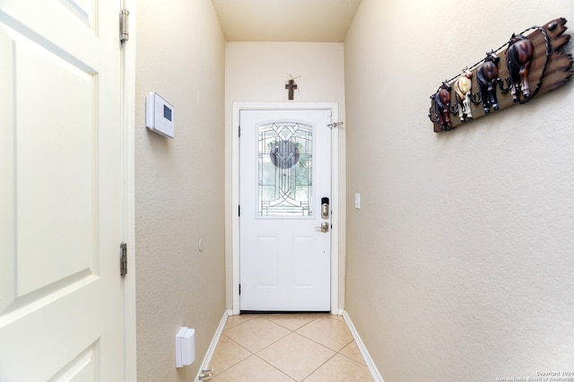 doorway to outside featuring light tile patterned flooring