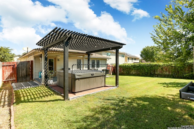 view of yard with a hot tub, a pergola, and a patio area