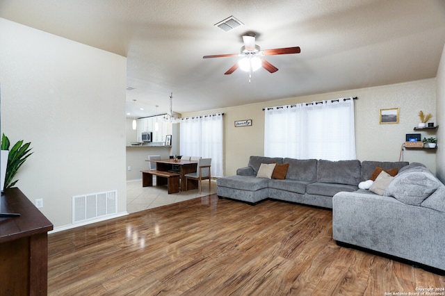 living room with ceiling fan and hardwood / wood-style floors