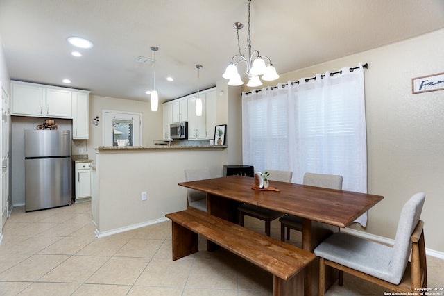 tiled dining space with a chandelier