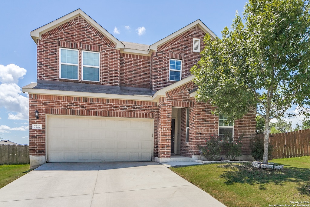 front of property with a garage and a front yard