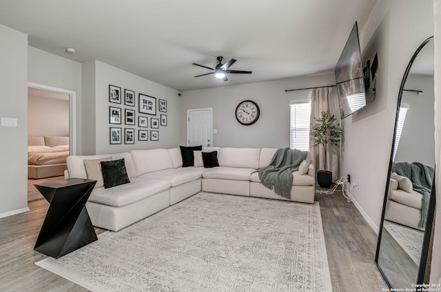 living room featuring hardwood / wood-style floors and ceiling fan