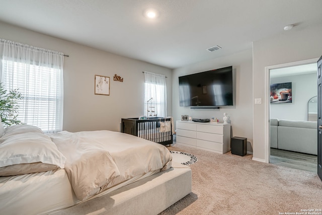 bedroom featuring light carpet