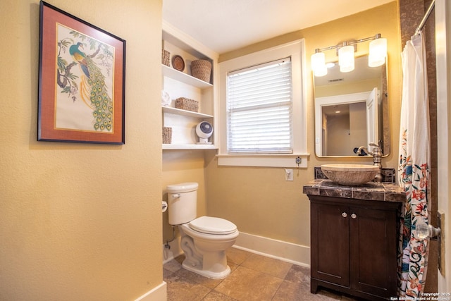 bathroom featuring vanity, tile patterned floors, and toilet