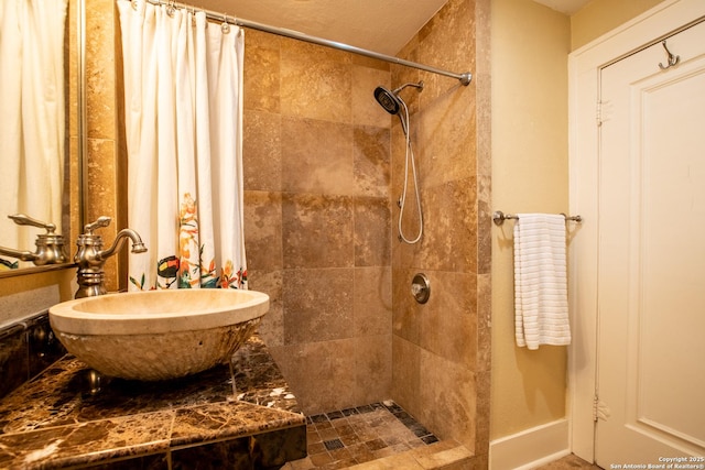 bathroom featuring a shower with curtain and sink