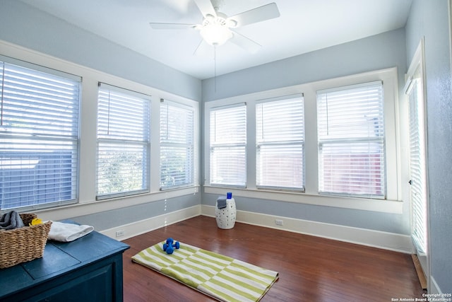 interior space with dark wood-type flooring and ceiling fan