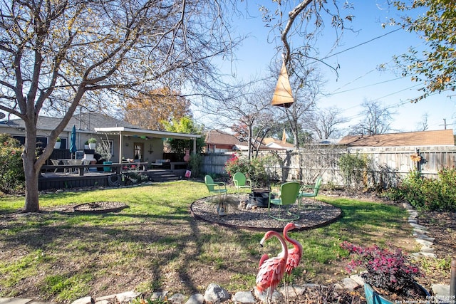 view of yard with a patio and an outdoor fire pit