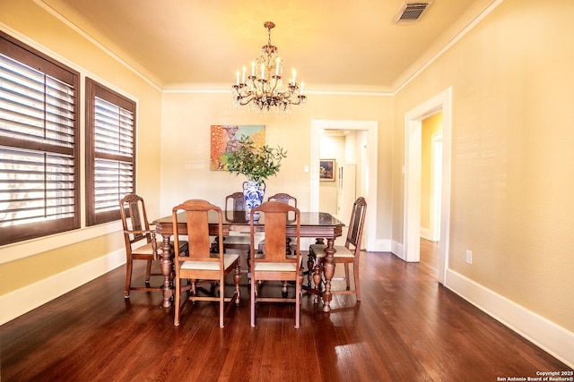 dining room with crown molding, dark hardwood / wood-style flooring, and a notable chandelier