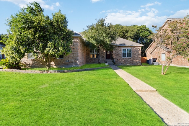 view of front of property featuring cooling unit and a front lawn