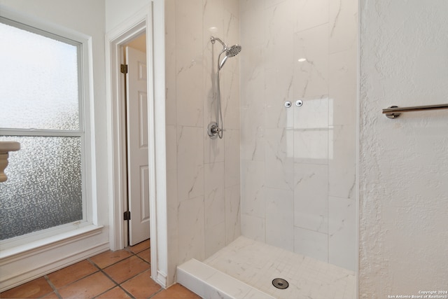 bathroom featuring a tile shower and tile patterned floors