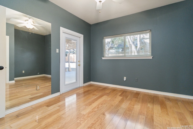 unfurnished room with hardwood / wood-style floors and ceiling fan