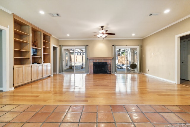 unfurnished living room with crown molding, built in shelves, ceiling fan, and light hardwood / wood-style floors