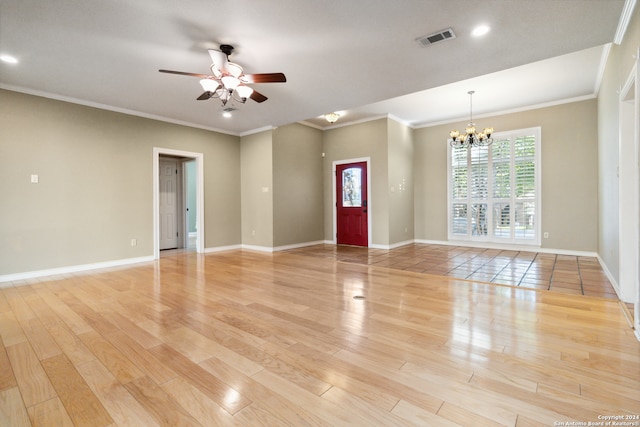 empty room featuring ceiling fan with notable chandelier, light wood-type flooring, and crown molding