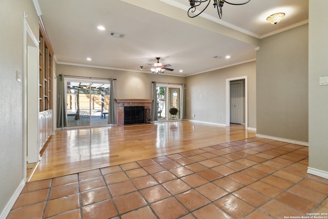 unfurnished living room featuring ceiling fan, ornamental molding, and wood-type flooring