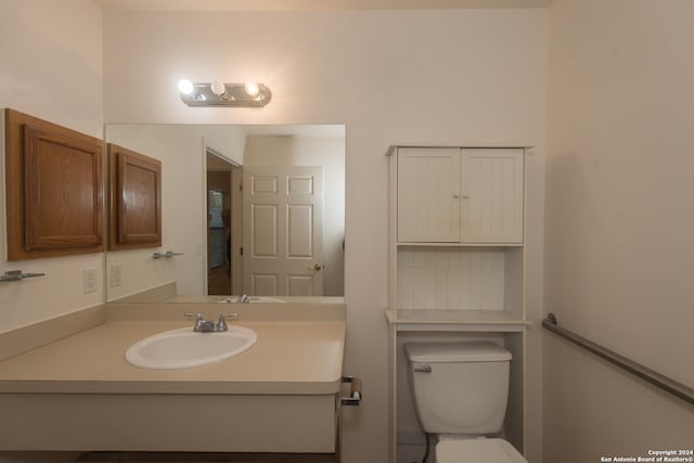 bathroom with toilet and vanity