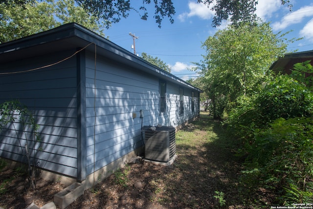 view of side of property with central AC