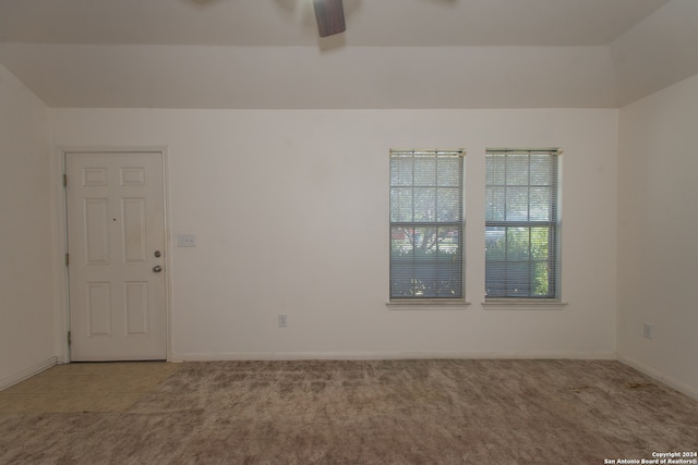 carpeted empty room featuring ceiling fan