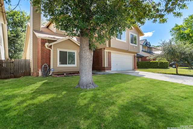 view of front of house with a front yard and a garage