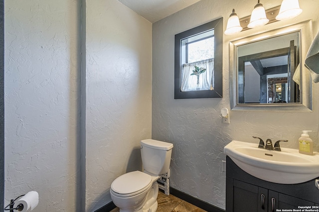 bathroom featuring toilet and vanity