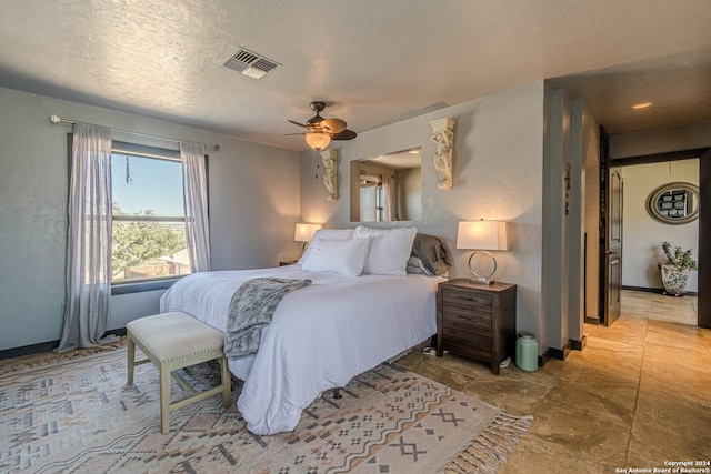 bedroom featuring a textured ceiling and ceiling fan